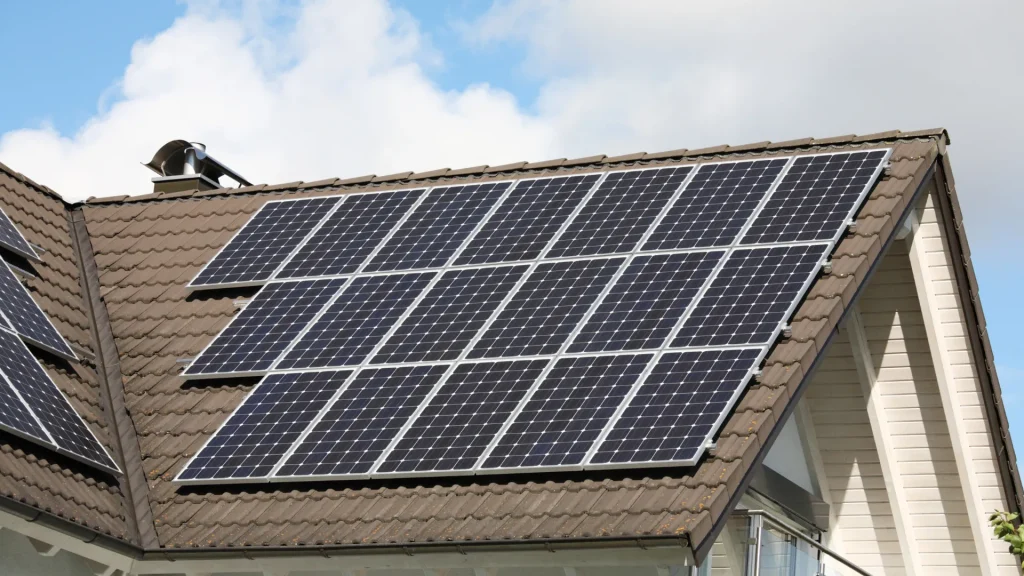 A residential pitched roof with multiple solar panels installed, illustrating a clean and efficient energy setup.