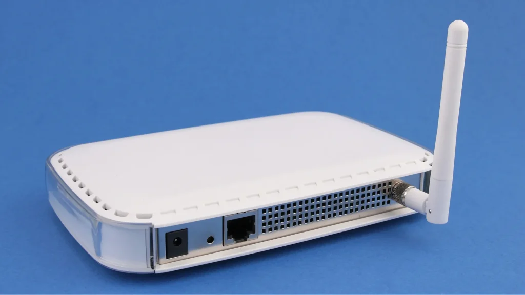 A white wireless router with an antenna, showcasing the rear ports, ideal for setting up a Point to Point Wireless Bridge Outdoor with Solar Panel integration.