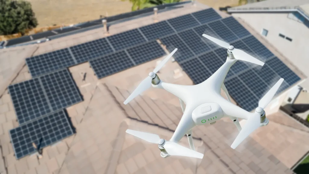 A solar panel cleaning drone hovering above a rooftop solar array, showcasing efficient cleaning technology.