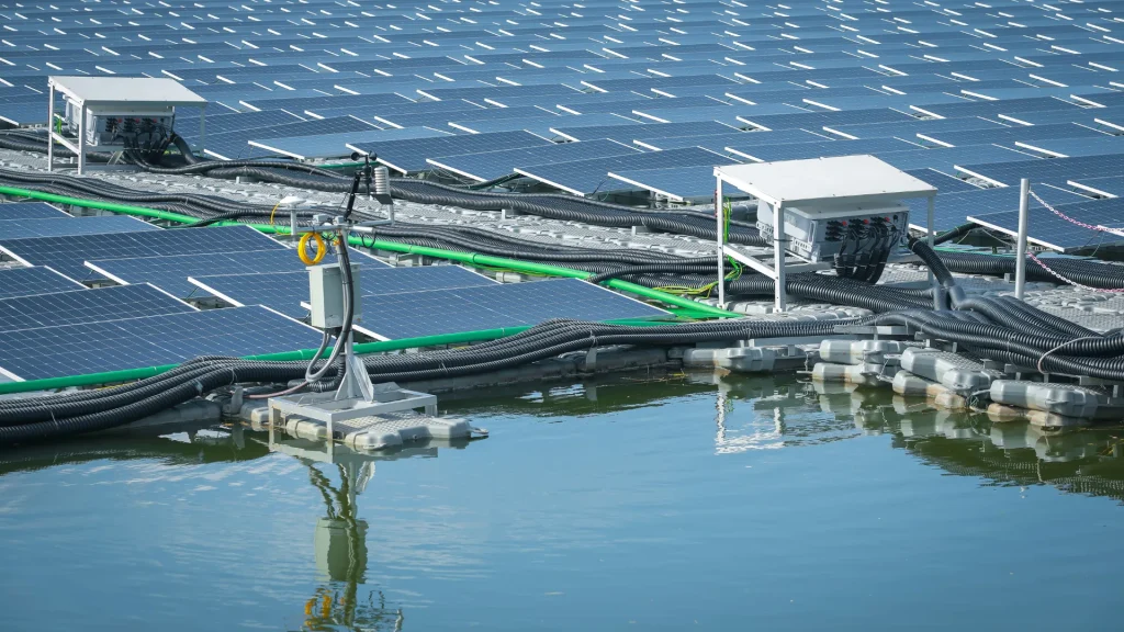 A floating solar panel system equipped with automated cleaning infrastructure, including a solar panel cleaning drone.