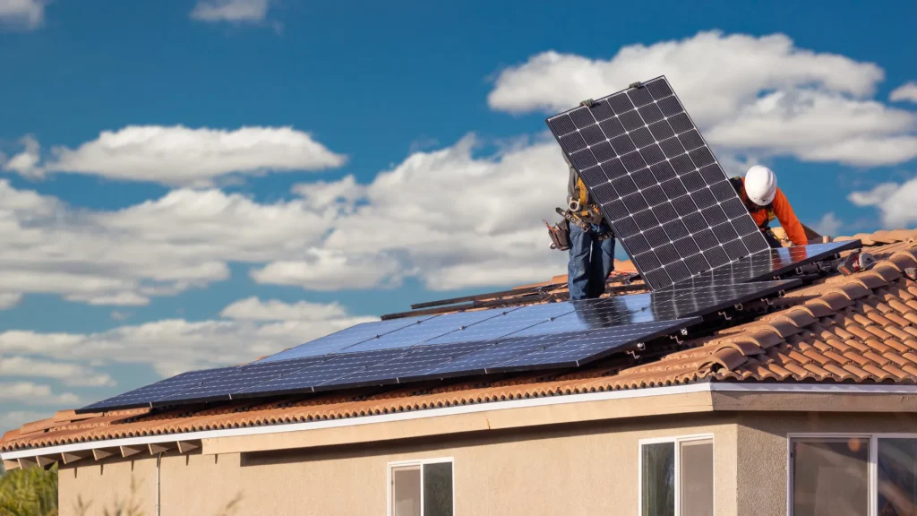 Workers installing Talesun 380 watt solar panels on a roof, showcasing their suitability for large-scale solar installations based on the Talesun 380 watt solar panels specifications.